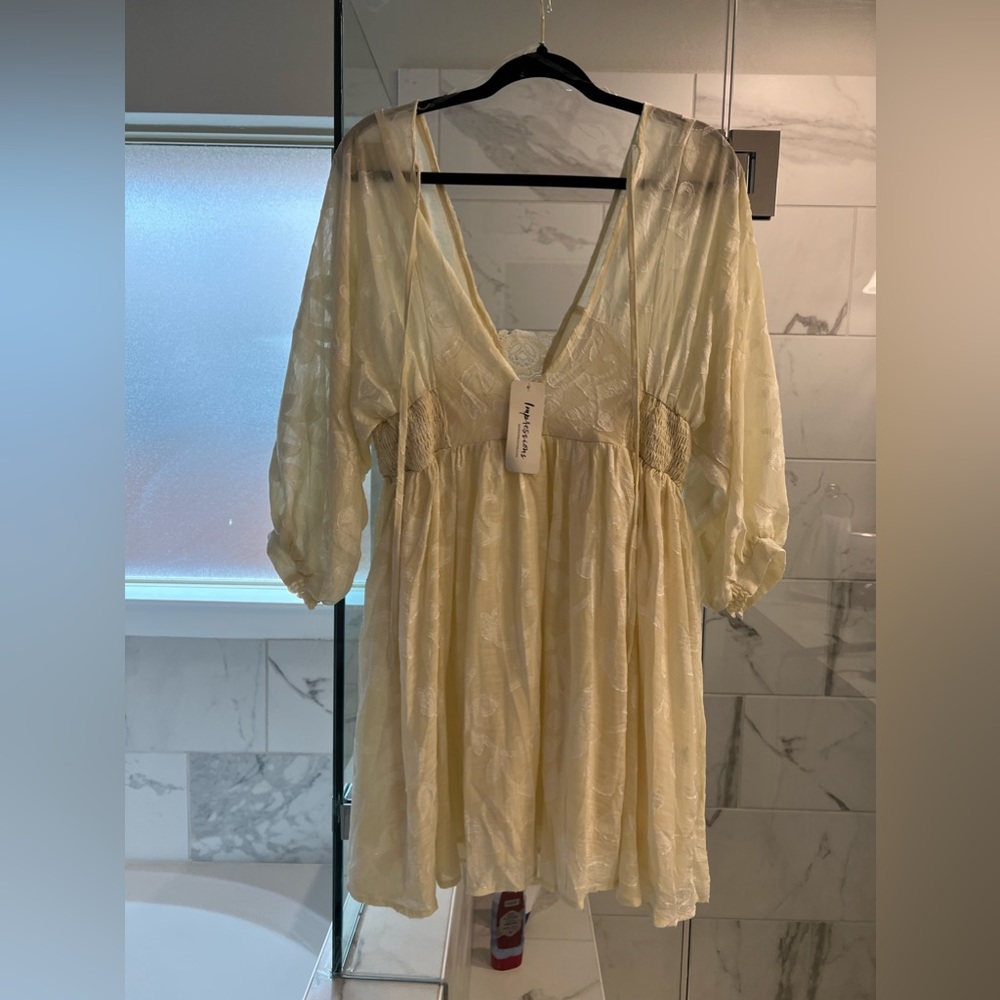 Off white lace baby doll dress. Size L. Never before worn, tags still on.